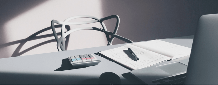 image of desk with calculator on it