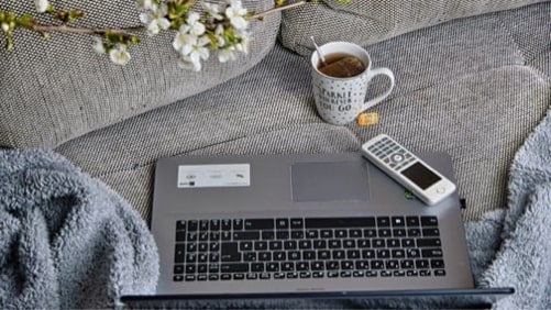 laptop couch and tea that illustrate working from home