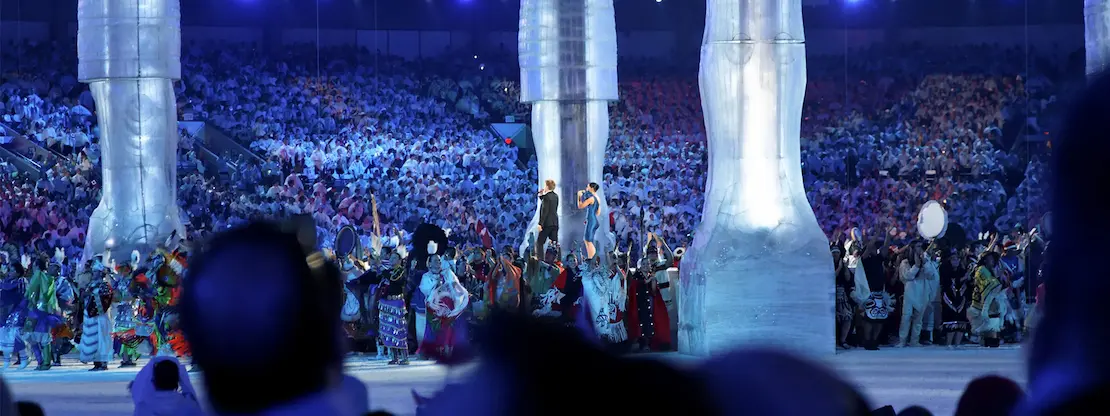 Winter Olympics opening ceremony in a packed stadium, highlighting large-scale event production and modern broadcast technology.