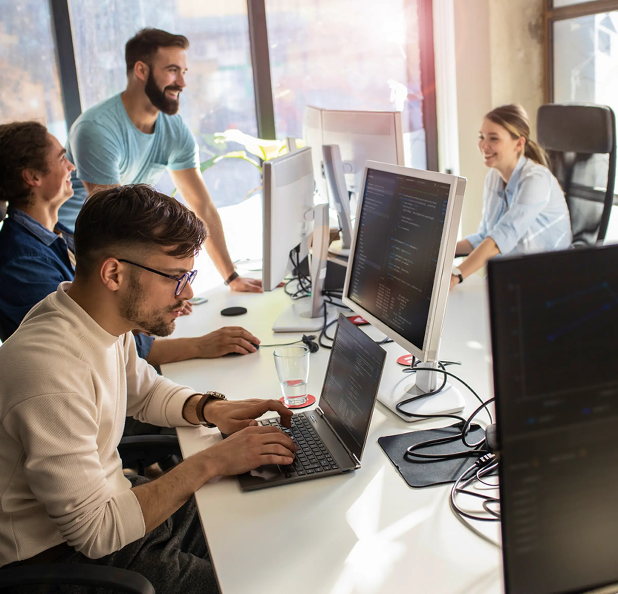 ObjectStyle team collaborating in the office providing IT staff augmentation services