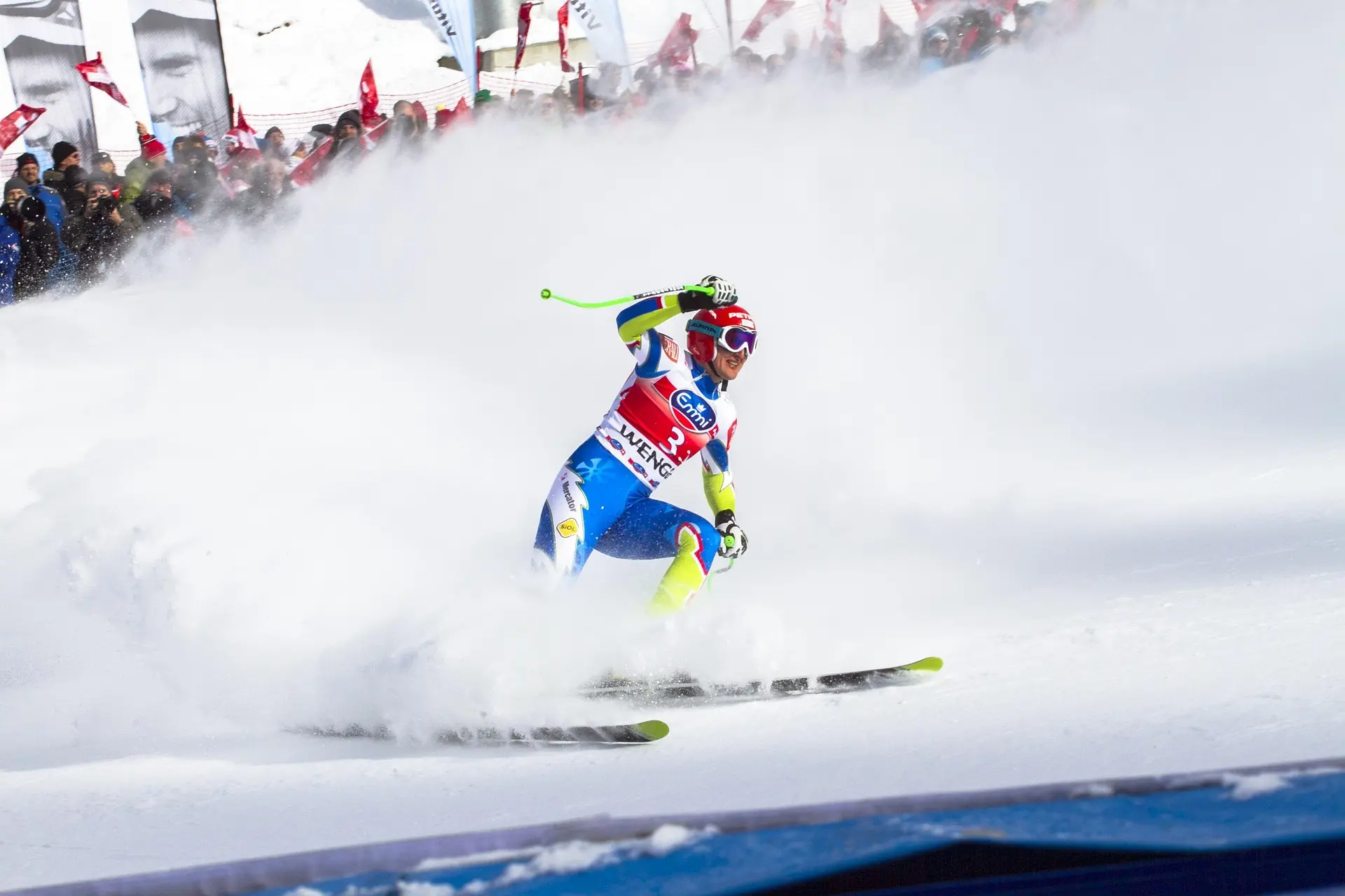 Alpine skier in race bib on snow, illustrating how equipment design and materials influence Winter Olympics performance.